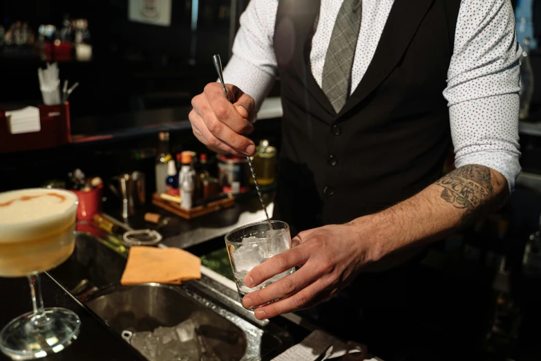 a bartender preparing a drink at a bar, by Ndoc Martini, profile image, lachlan bailey, extra detail, multiple stories