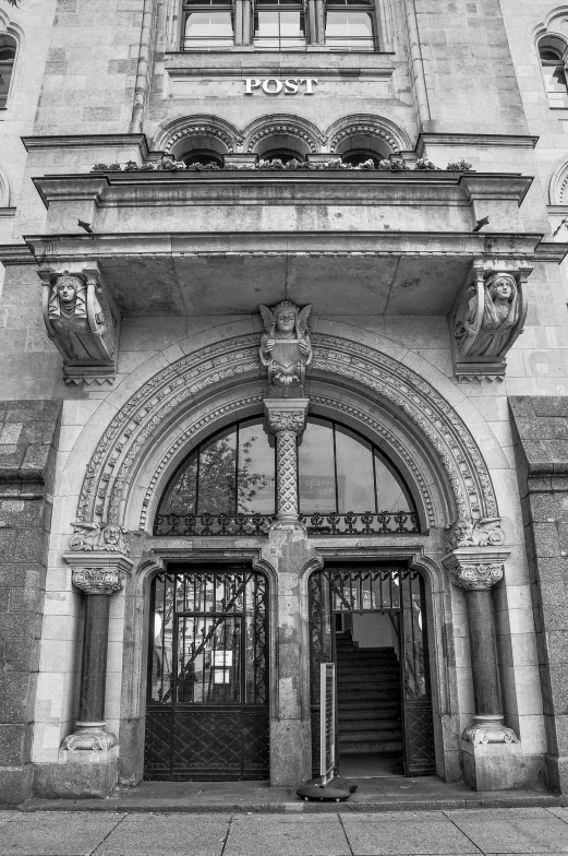 a black and white photo of a building, a black and white photo, inspired by Sir Jacob Epstein, art nouveau, private academy entrance, an archway, wunderkammer, photograph taken in 2 0 2 0