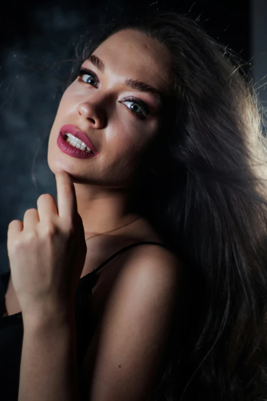 a woman with long hair posing for a picture, an album cover, by Adam Marczyński, trending on pexels, glossy lips, candid!! dark background, 5 0 0 px models, non binary model