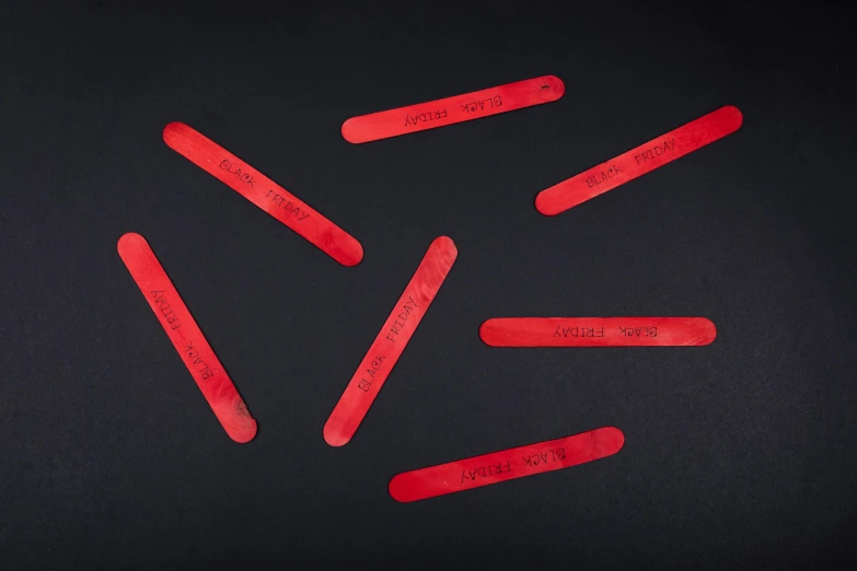 a bunch of red sticks sticking out of a black surface, inspired by Okada Hanko, unsplash, serial art, etched inscriptions, full product shot, plays skateboards, red painted metal