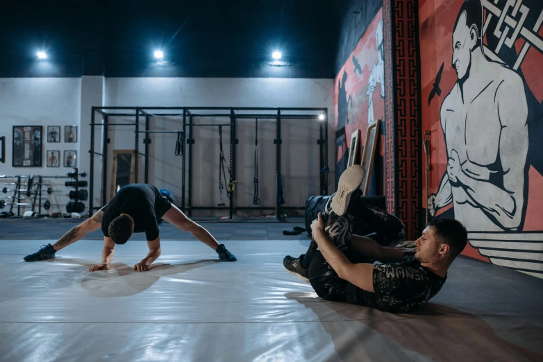 two men doing push ups in a gym, by Julia Pishtar, pexels contest winner, graffiti, ninja warrior, doing splits and stretching, thumbnail, olga buzova