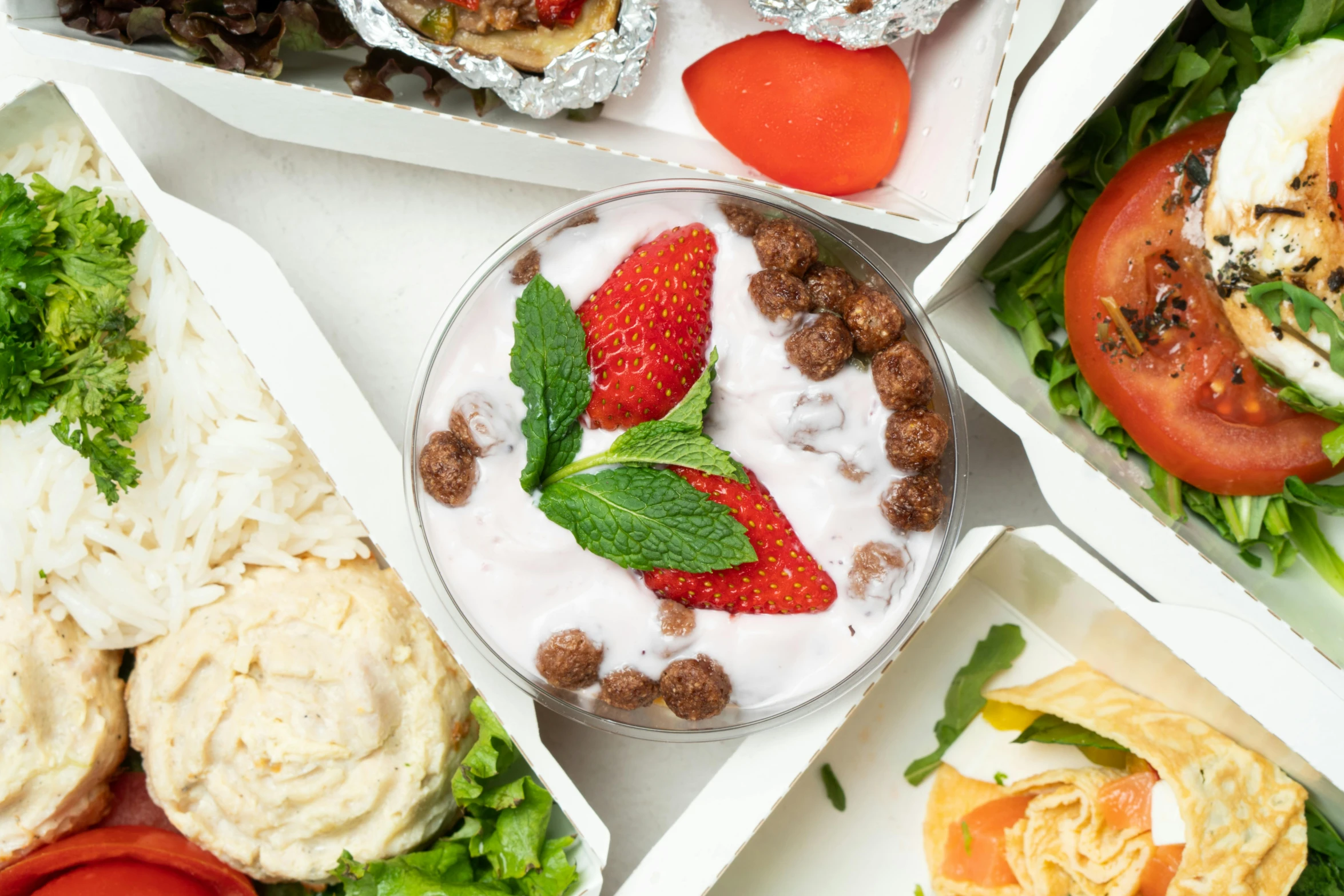 a table topped with lots of different types of food, a picture, yogurt, strawberry ninja, closeup - view, epicurious