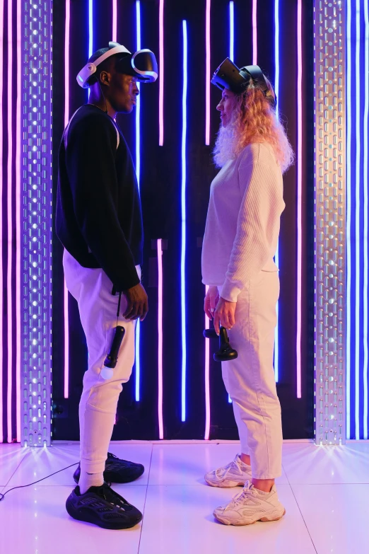 a couple of people standing next to each other on a stage, interactive art, neon background lighting, champagne commercial, future clothing, ( ( theatrical ) )