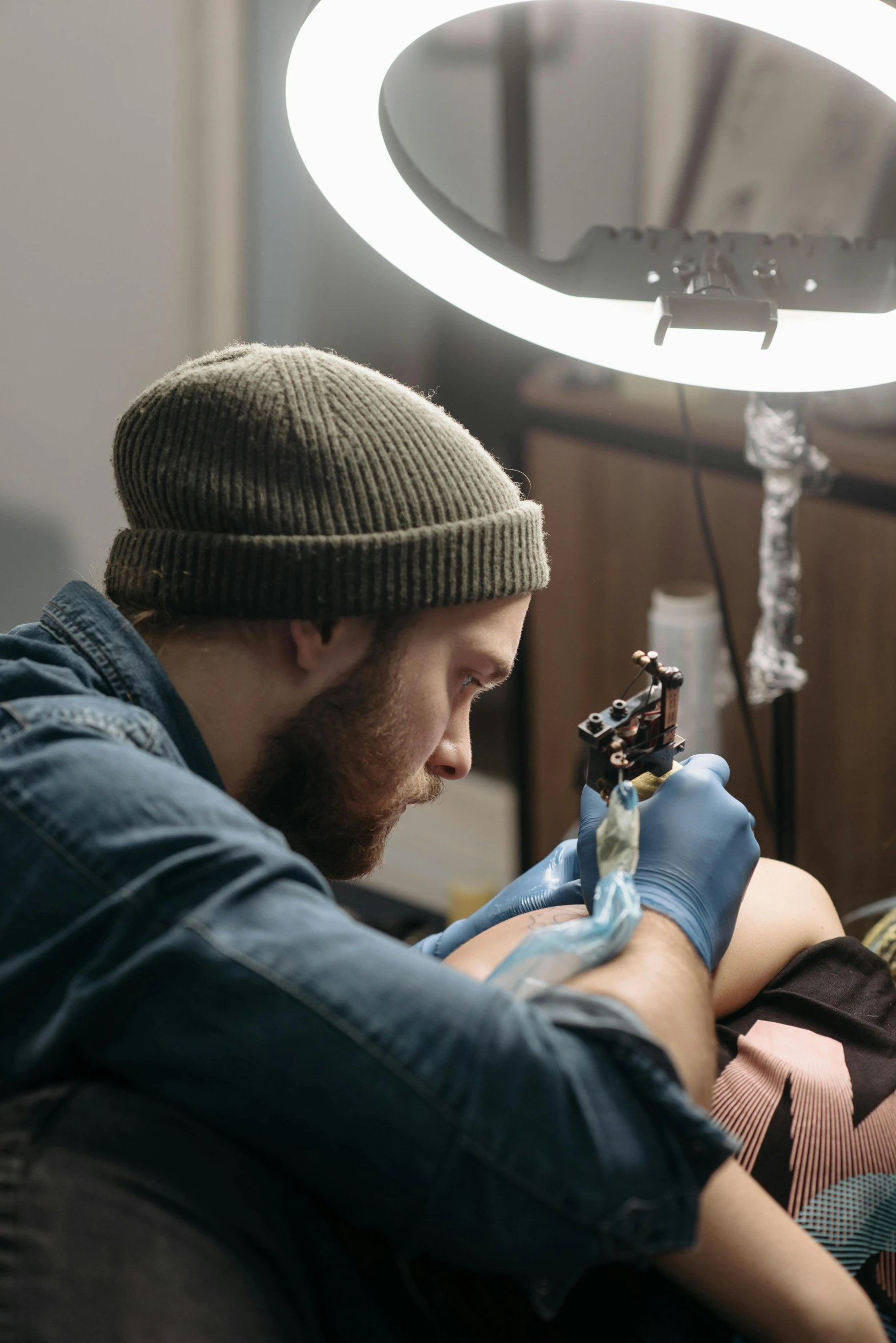 a man getting a tattoo on a woman's arm, a tattoo, by artist, trending on pexels, hyperrealism, stitching, man playing guitar, sad man, glowing tattoos