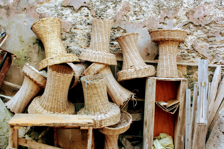 a pile of baskets sitting on top of a wooden chair, arte povera, thumbnail, egypt, buttresses, brown