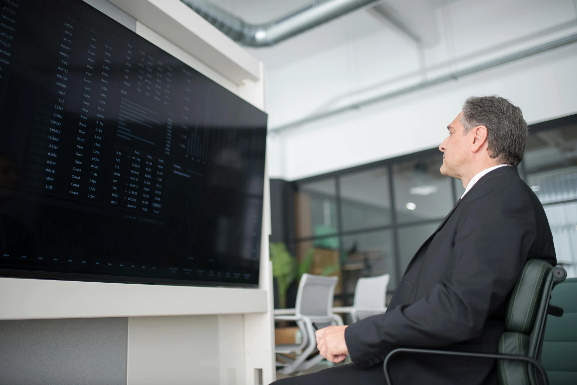 a man sitting in a chair in front of a computer monitor, datacentre, tech demo, slightly minimal, tv still