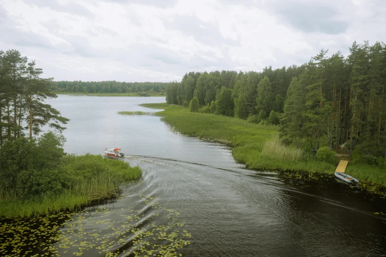 a boat traveling down a river next to a forest, by Grytė Pintukaitė, hurufiyya, shot on hasselblad, lake view, high - angle view, vladimir krisetskiy