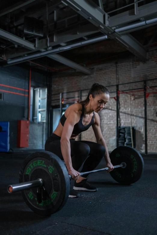 a woman squatting with a barbell in a gym, a portrait, by Adam Marczyński, pexels contest winner, pulling the move'the banshee ', headshot, instagram post, rectangle