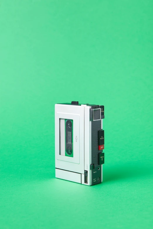 a cassette player sitting on top of a green surface, by Werner Gutzeit, private press, mit technology review, promo image, left profile, ffffound