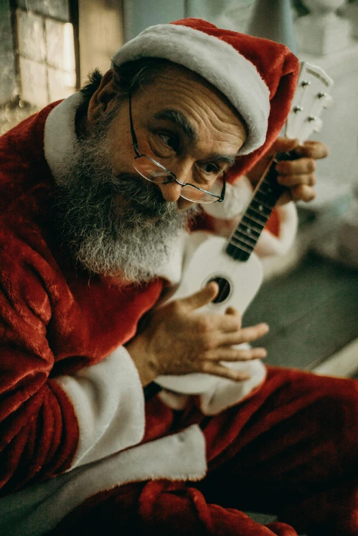 a man in a santa suit playing a guitar, an album cover, pexels, ukulele, profile image, alessio albi, 5 5 yo