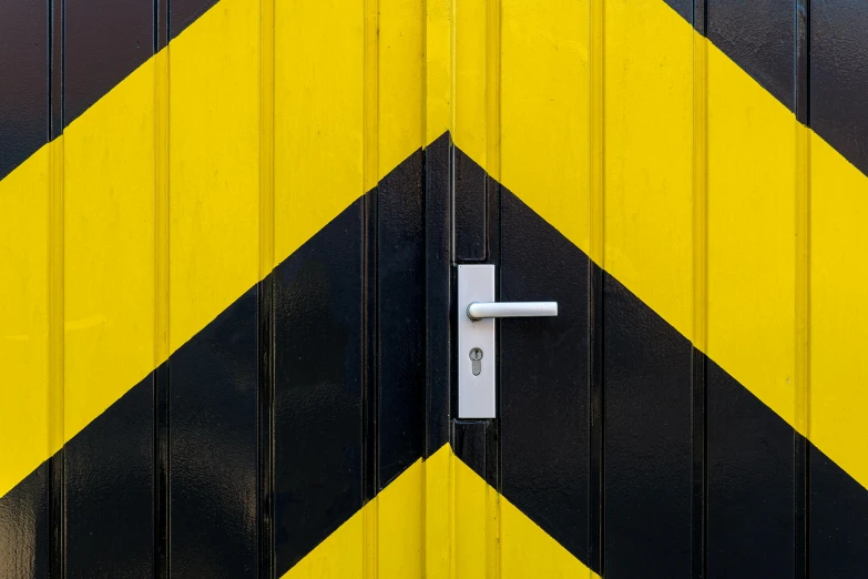 a close up of a yellow and black door, inspired by Frederick Hammersley, unsplash, hazard stripes, a wooden, padlocks, zig zag