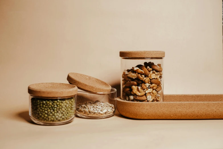 a couple of jars filled with food sitting on top of a table, unsplash, assemblage, sustainable materials, brown, terrazzo, rectangle