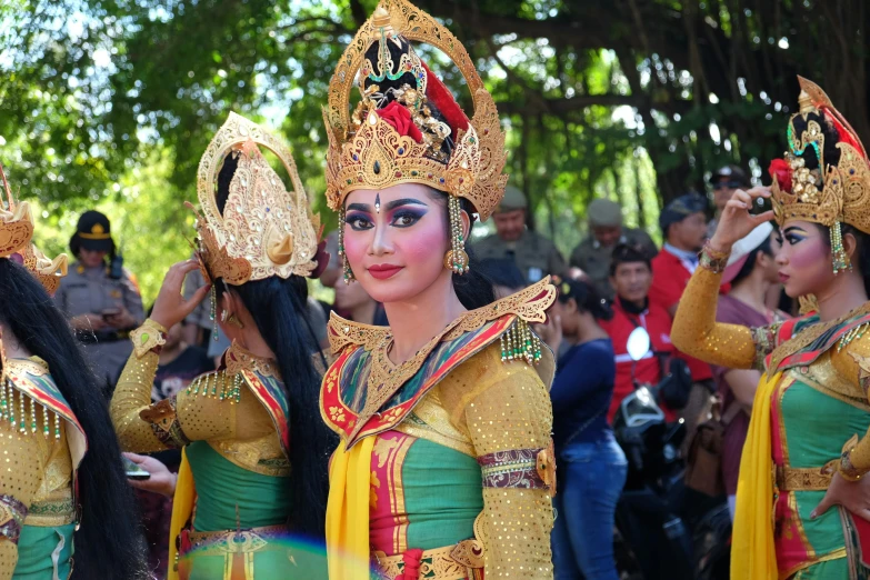 a group of women standing next to each other, pexels contest winner, sumatraism, wearing an elaborate helmet, avatar image, performance, square