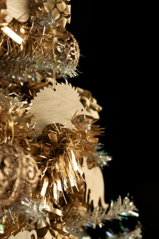 a close up of a christmas tree with ornaments, an album cover, by Paul Davis, baroque, laser cut, golden feathers, detail shot, close - up photograph