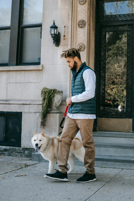 a man walking a dog down a sidewalk, trending on pexels, renaissance, model is wearing techtical vest, green corduroy pants, handsome chad chin, gif