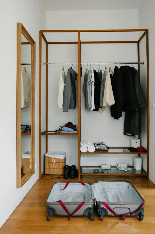 an open suitcase sitting on top of a hard wood floor, by Nina Hamnett, minimalism, two wooden wardrobes, japanese collection product, casual streetwear, in karuizawa