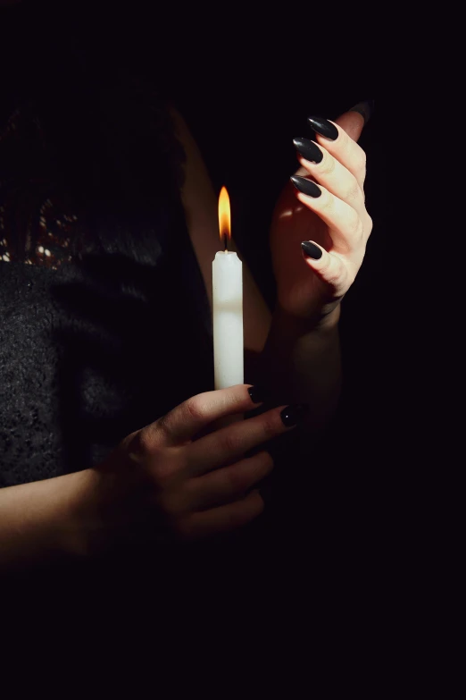 a woman holding a lit candle in her hands, an album cover, inspired by Elsa Bleda, trending on pexels, gothic clothing, mourning, instagram photo, ilustration