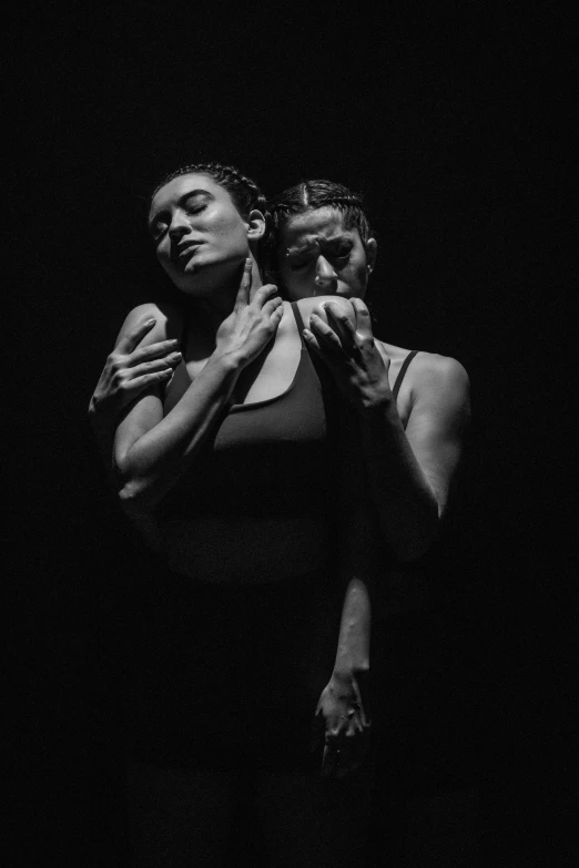 a woman holding a baby in her arms, a black and white photo, by Alexis Grimou, modern dance aesthetic, lorde, couple, liam brazier and nielly