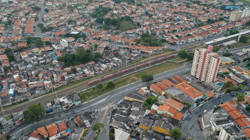 an aerial view of a city with lots of buildings, by Fernando Gerassi, reddit, trains in the background, 2000s photo, henrique alvim corrêa, taken in 2022