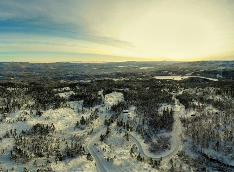 a snow covered forest filled with lots of trees, inspired by Einar Hakonarson, pexels contest winner, les nabis, aerial view of an ancient land, panorama distant view, hdri, sun setting