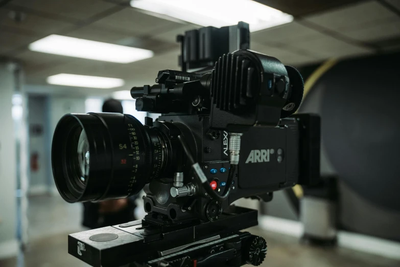 a close up of a camera on a tripod, arri alfa anamorphic lens, v-ray 8k uhd, b - roll, looking towards the camera