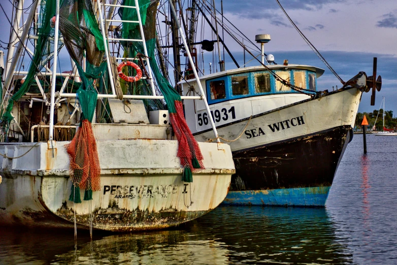 a couple of boats that are sitting in the water, a portrait, by Greg Spalenka, pixabay contest winner, fish seafood markets, southern gothic art, profile image, unsplash photo contest winner