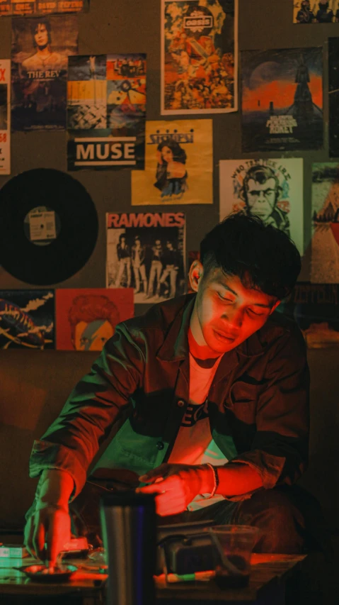 a man sitting in front of a laptop computer, an album cover, inspired by Liam Wong, trending on pexels, declan mckenna, studious chiaroscuro, portrait of danny gonzalez, museum quality photo