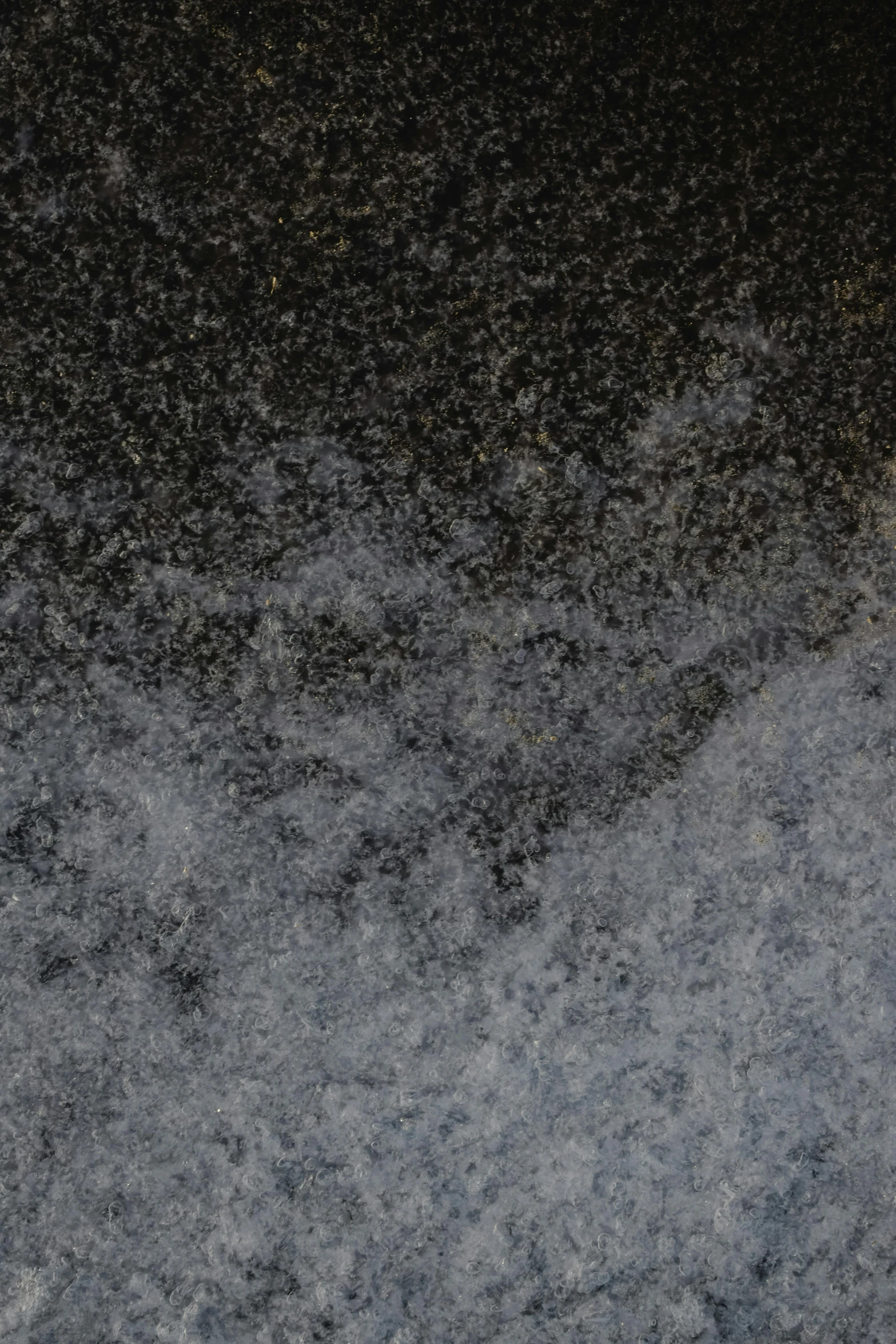 a man riding a snowboard down a snow covered slope, an album cover, inspired by Arthur Burdett Frost, trending on unsplash, tonalism, high resolution coal texture, granite, microscopic detail, panel of black