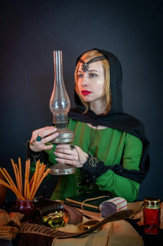 a woman dressed as a witch holding a lamp, inspired by Osman Hamdi Bey, featured on reddit, renaissance, alchemist bottles, studio photo, green steampunk lasers, portrait of bedouin d&d