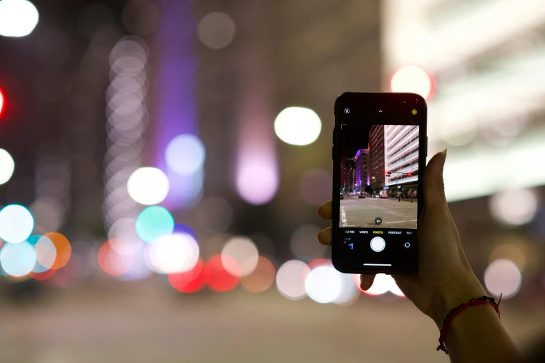 a person taking a picture of a street at night, a picture, fan favorite, iphone video, pixelated, features