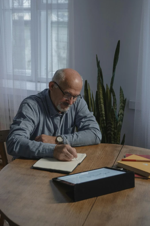 a man sitting at a table writing on a piece of paper, anton fadeev 8 k, mike ehrmantraut, profile image, at home