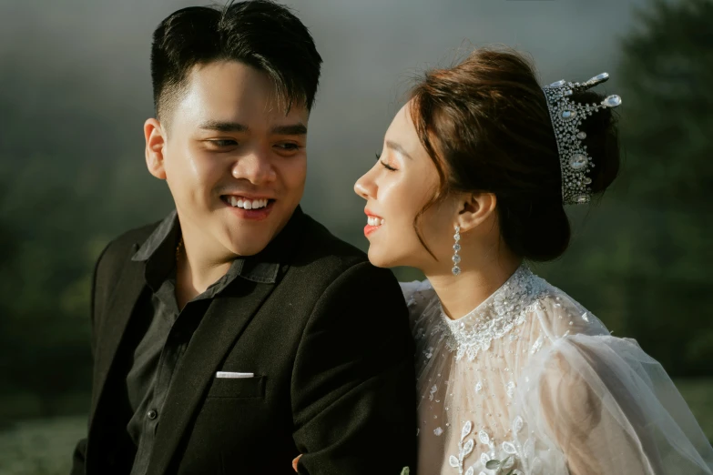 a man and a woman sitting next to each other, a picture, pexels contest winner, ao dai, headshot profile picture, wearing a diamond crown, smiling confidently