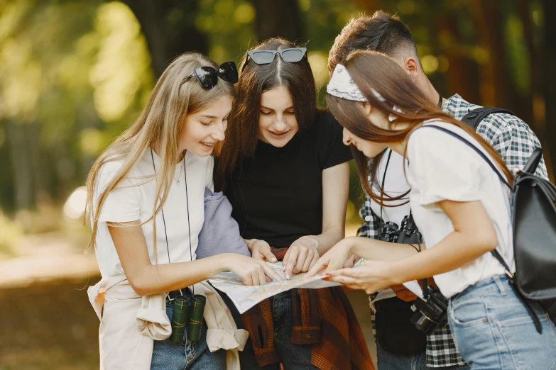 a group of young people looking at a map, by Emma Andijewska, trending on pexels, cute girls, 15081959 21121991 01012000 4k, avatar image, summer season