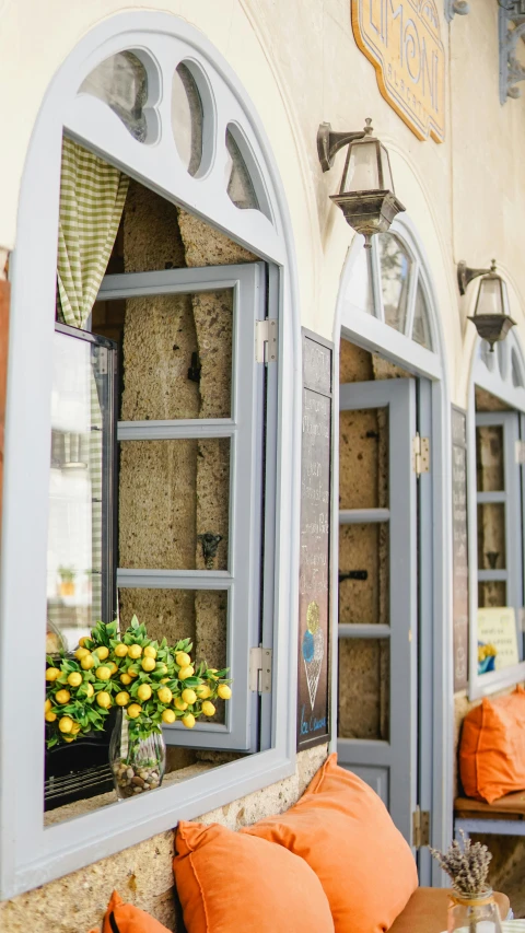 a couple of windows sitting next to each other, by Alexander Fedosav, unsplash, yellow lanterns, greek setting, restaurant exterior photography, square