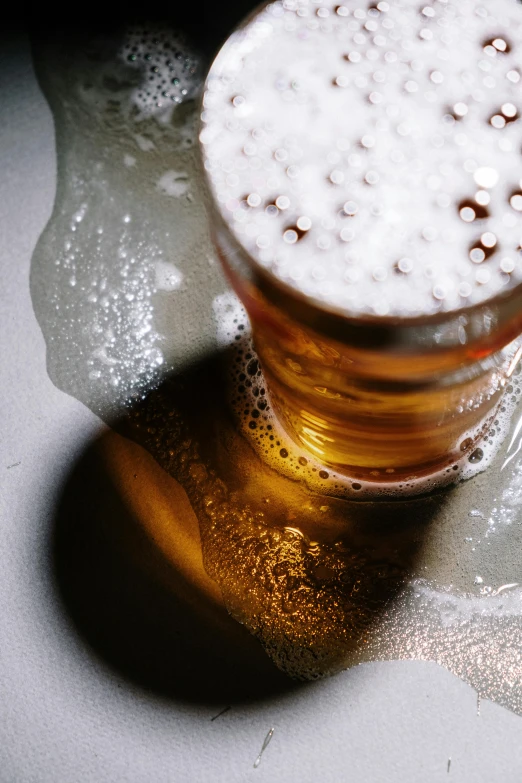 a glass of beer sitting on top of a table, unsplash, renaissance, very sweaty, soft rim light, sink, battle toast