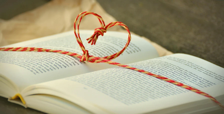 an open book with a string in the shape of a heart, by Sylvia Wishart, pixabay, instagram picture, gifts, 15081959 21121991 01012000 4k, friendship