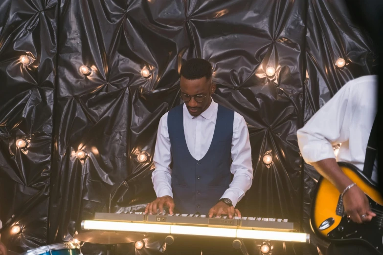 a man that is standing in front of a keyboard, inspired by Michael Ray Charles, pexels, funk art, 3 jazz musicians, wedding, illuminated, 3 / 4 wide shot