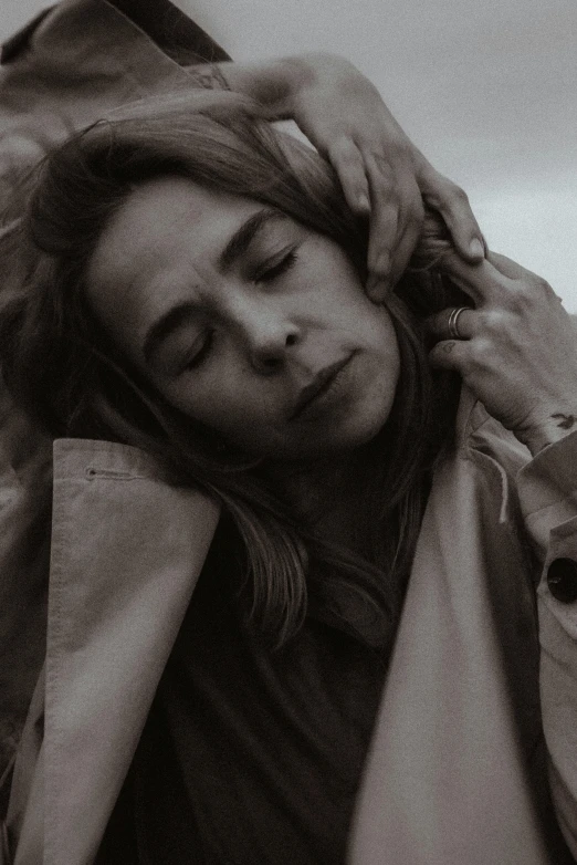 a black and white photo of a woman with her eyes closed, trending on pexels, hyperrealism, movie still of a tired, in style of britt marling, sepia photography, video still