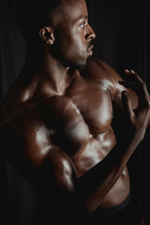 a man posing for a picture in the dark, an album cover, by Terrell James, pexels contest winner, hyperrealism, huge glistening muscles, beautiful male drow, covered in oil, chest