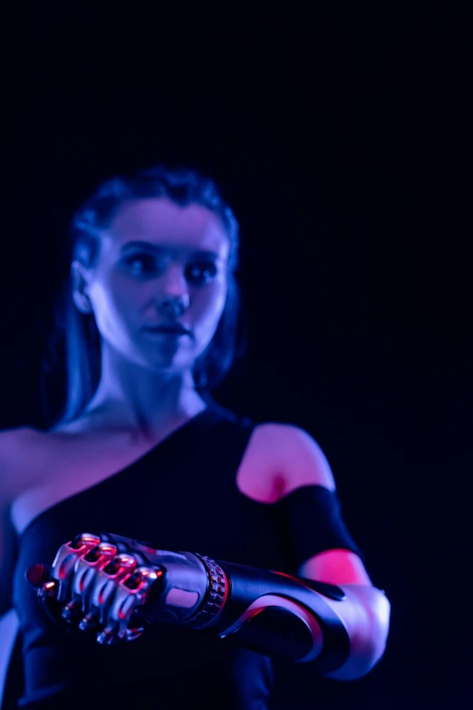 a woman in a black dress holding a red glove, unsplash, holography, futuristic fashion show, robotic prosthetic arm, portrait sophie mudd, with glowing blue lights