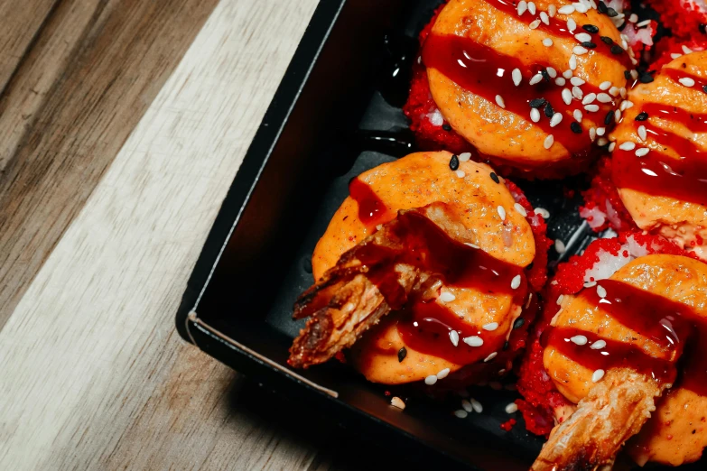 a close up of a tray of food on a table, holding hot sauce, crispy buns, avatar image, prawn