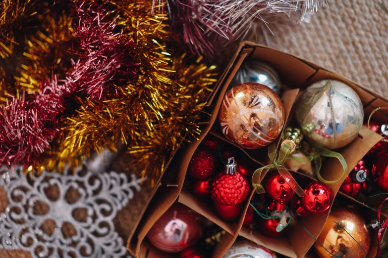 a box filled with christmas ornaments on top of a table, pexels contest winner, brown, avatar image, fan favorite, full of colour