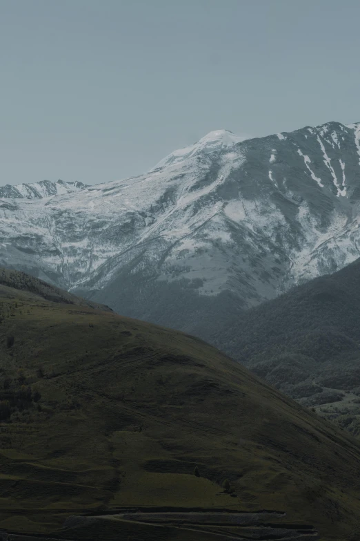 a mountain range with snow covered mountains in the distance, a matte painting, unsplash contest winner, hurufiyya, nadav kander, still from a music video, new zealand, high polygon