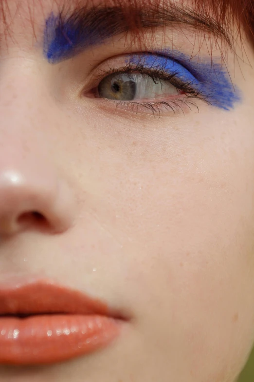 a close up of a person with blue eyes, inspired by Yves Klein, trending on pexels, pat mcgrath, blue and orange, pale skin, porcelain skin ”