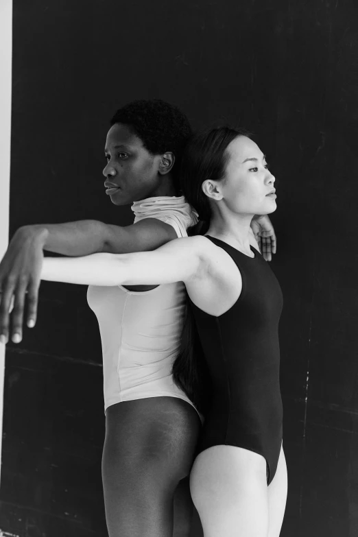 two women in leo leo leo leo leo leo leo leo leo leo leo leo leo leo leo, a black and white photo, inspired by Wang Duo, arabesque, jeffrey smith and rlon wang, adut akech, pose 4 of 1 6, looking from shoulder