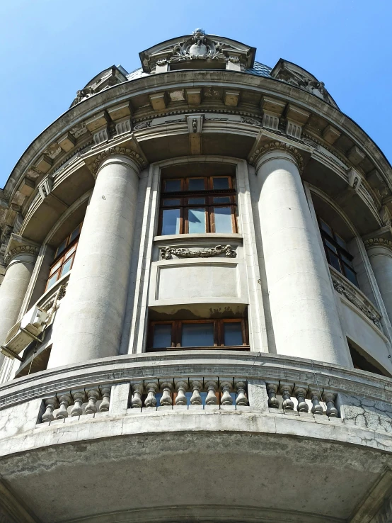 a tall building with a clock on top of it, romanian heritage, circular windows, thumbnail, marble columns