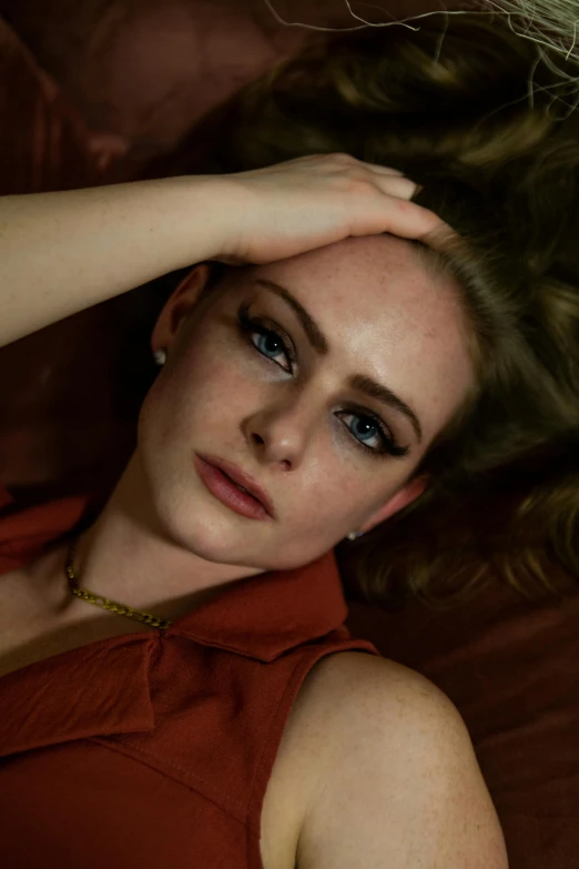 a beautiful young woman laying on top of a bed, a portrait, inspired by Nan Goldin, trending on pexels, photorealism, sophie turner, 70s photo, evan rachel wood, square