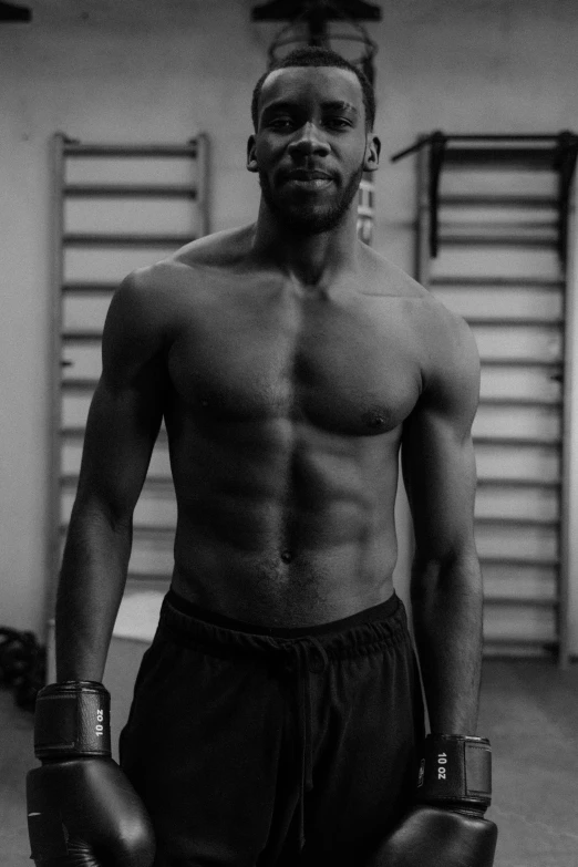 a black and white photo of a man with boxing gloves, by Theo Constanté, figuration libre, sweaty abs, mkbhd as iron man, morgan freeman as gordon freeman, athletic build