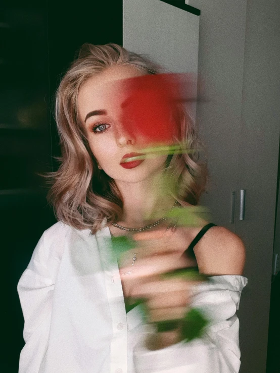 a woman holding a rose in front of her face, a colorized photo, inspired by Elsa Bleda, trending on pexels, portrait of kim petras, blurred photo, 👅 👅, sexy girl with green eyes