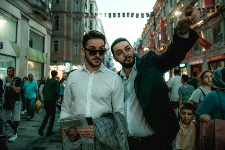 a couple of men standing next to each other on a street, a photo, pexels contest winner, happening, turkish and russian, avatar image, taking a selfie, wearing a suit and glasses